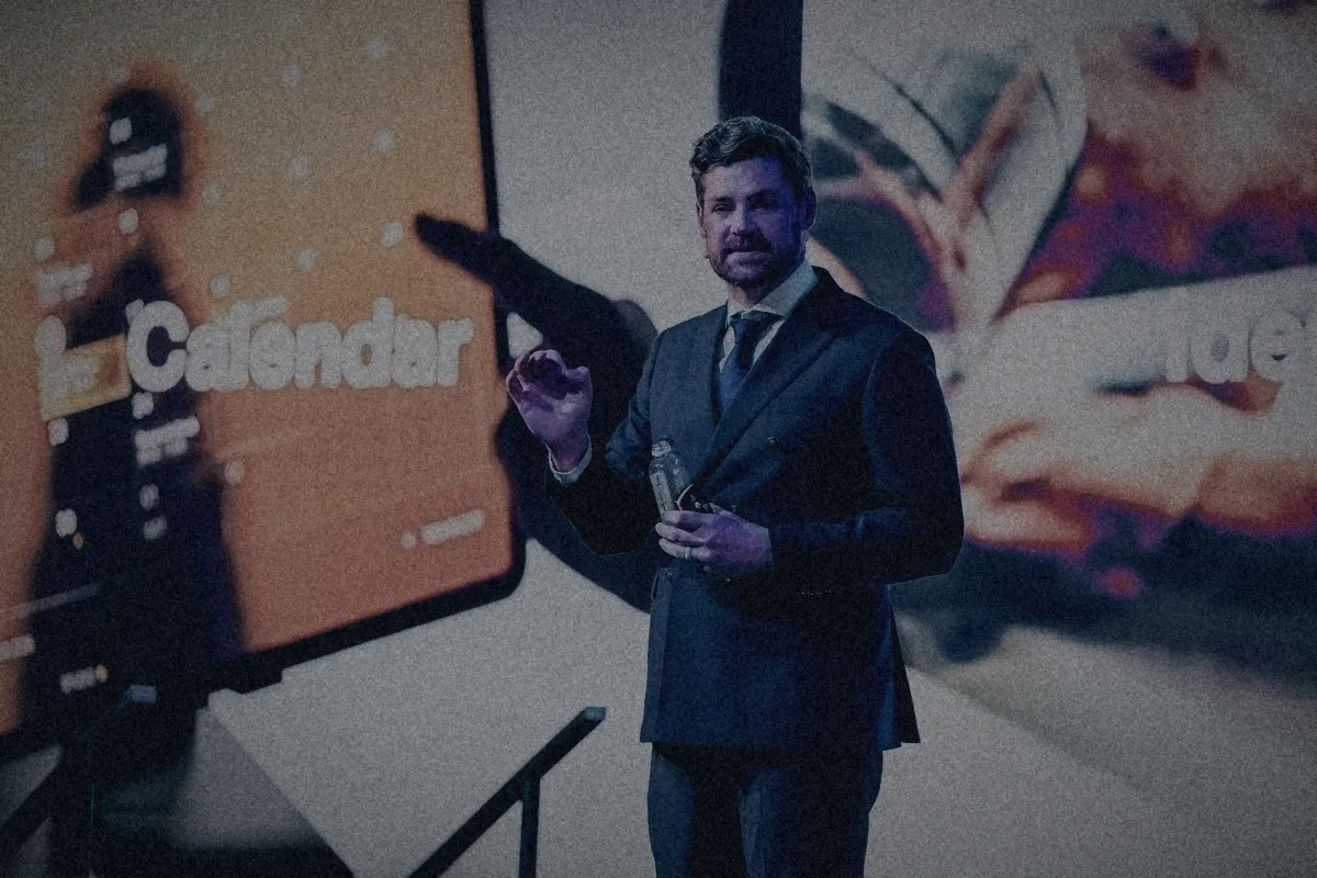 Erik Kruger presenting in front of a large screen during a keynote