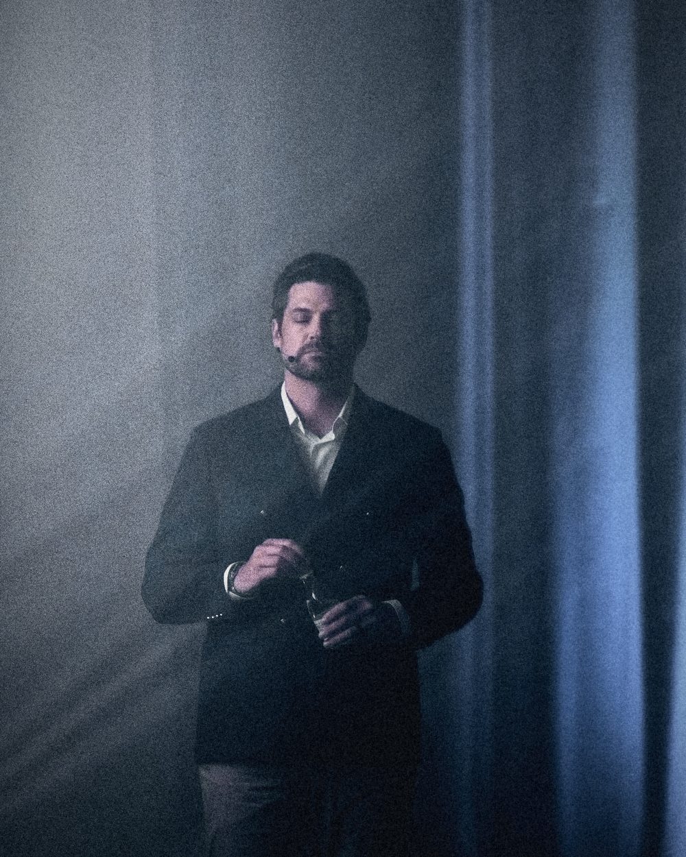 Erik Kruger on stage in a hazy spotlight