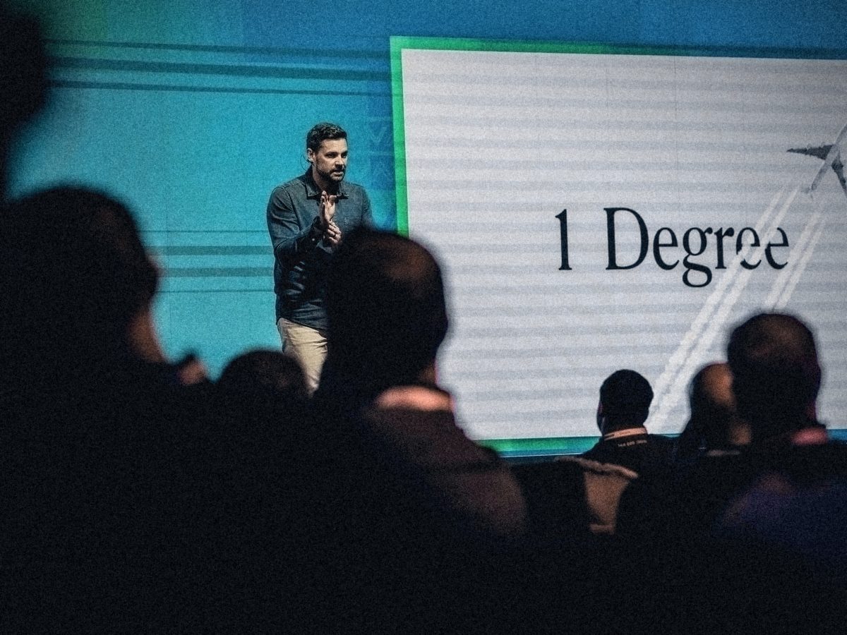 Erik Kruger engaging the audience during a keynote, seen from the crowd